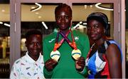 19 July 2021; Rhasidat Adeleke of Ireland with her brother Abdullahi and mother Adewumi Ademola and her Women's 100m and 200m gold medals at Dublin Airport as Team Ireland return home from the European U20 Athletics Championships. Photo by Sam Barnes/Sportsfile