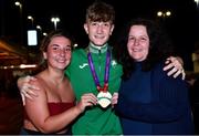 19 July 2021; Nicholas Griggs of Ireland with his mother Royanne and friend Dominika Bobotova and with his Men's 3000m gold medal at Dublin Airport as Team Ireland return home from the European U20 Athletics Championships. Photo by Sam barnes/Sportsfile