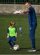 20 July 2021; Republic of Ireland Under-21 Manager Jim Crawford with Ruadh Pierce, aged six, during Football For All INTERsport Elverys Summer Soccer School at Carrigaline United AFC, Carrigaline in Cork. Photo by Harry Murphy/Sportsfile