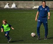 20 July 2021; Republic of Ireland Under-21 Manager Jim Crawford with Ruadh Pierce, aged six, during Football For All INTERsport Elverys Summer Soccer School at Carrigaline United AFC, Carrigaline in Cork. Photo by Harry Murphy/Sportsfile