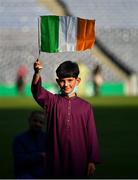 20 July 2021; Ten year old Ali Khan, from Clonsilla in Dublin, waves a Tricolour on the pitch during the celebration of Eid Al-Adha at Croke Park in Dublin. Photo by Ray McManus/Sportsfile
