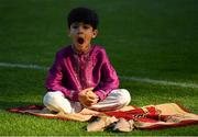 20 July 2021; A young boy yawns on the pitch during the celebration of Eid Al-Adha at Croke Park in Dublin. Photo by Ray McManus/Sportsfile