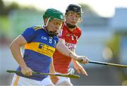 20 July 2021; James Devanney of Tipperary in action against Eoin Downey of Cork during the Munster GAA Hurling U20 Championship semi-final match between Tipperary and Cork at Semple Stadium in Thurles, Tipperary. Photo by Ben McShane/Sportsfile
