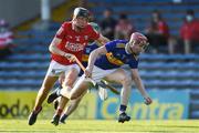 20 July 2021; Sean Hayes of Tipperary in action against Eoin Downey of Cork during the Munster GAA Hurling U20 Championship semi-final match between Tipperary and Cork at Semple Stadium in Thurles, Tipperary. Photo by Ben McShane/Sportsfile