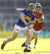 20 July 2021; James Devanney of Tipperary in action against Jack Cahalane of Cork during the Munster GAA Hurling U20 Championship semi-final match between Tipperary and Cork at Semple Stadium in Thurles, Tipperary. Photo by Ben McShane/Sportsfile
