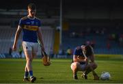 20 July 2021; Devon Ryan of Tipperary, right, dejected after his side's defeat in the Munster GAA Hurling U20 Championship semi-final match between Tipperary and Cork at Semple Stadium in Thurles, Tipperary. Photo by Ben McShane/Sportsfile