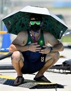 21 July 2021; Ireland coach Nico Peschier takes shade under an umbrella during a training session at the Kasai Canoe Slalom Centre ahead of the start of the 2020 Tokyo Summer Olympic Games in Tokyo, Japan. Photo by Brendan Moran/Sportsfile