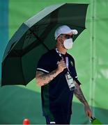 21 July 2021; Ireland team manager Jon Mackey takes shade under an umbrella during a training session at the Kasai Canoe Slalom Centre ahead of the start of the 2020 Tokyo Summer Olympic Games in Tokyo, Japan. Photo by Brendan Moran/Sportsfile