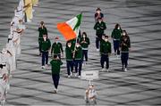 23 July 2021; Light heavyweight Emmet Brennan uses his phone to record proceedings as Team Ireland flagbearers Kellie Harrington, right, and Brendan Irvine carry the Irish tricolour during the 2020 Tokyo Summer Olympic Games opening ceremony at the Olympic Stadium in Tokyo, Japan. Photo by Stephen McCarthy/Sportsfile