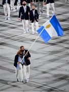 23 July 2021; Team Argentina flagbearers Cecilia Carranza Saroli and Santiago Raul Lange carry the Argentian flag during the 2020 Tokyo Summer Olympic Games opening ceremony at the Olympic Stadium in Tokyo, Japan. Photo by Stephen McCarthy/Sportsfile