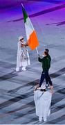 23 July 2021; Team Ireland flagbearers Kellie Harrington and Brendan Irvine carry the Irish tricolour during the 2020 Tokyo Summer Olympic Games opening ceremony at the Olympic Stadium in Tokyo, Japan. Photo by Brendan Moran/Sportsfile