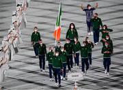 23 July 2021; Light heavyweight Emmet Brennan uses his phone to take a picture as Team Ireland flagbearers Kellie Harrington, right, and Brendan Irvine carry the Irish tricolour during the 2020 Tokyo Summer Olympic Games opening ceremony at the Olympic Stadium in Tokyo, Japan. Photo by Stephen McCarthy/Sportsfile