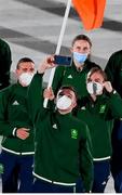 23 July 2021; Light heavyweight Emmet Brennan uses his phone to take a picture as Team Ireland flagbearers Kellie Harrington, right, and Brendan Irvine carry the Irish tricolour during the 2020 Tokyo Summer Olympic Games opening ceremony at the Olympic Stadium in Tokyo, Japan. Photo by Stephen McCarthy/Sportsfile