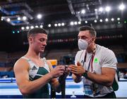 24 July 2021; (EDITOR'S NOTE: This image was created using a starburst filter) Rhys McClenaghan of Ireland with national gymnastics coach Luke Carson after competing on the Pommel Horse in artistic gymnastics qualification at the Ariake Gymnastics Centre during the 2020 Tokyo Summer Olympic Games in Tokyo, Japan. Photo by Ramsey Cardy/Sportsfile