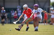 24 July 2021; Kate Wall of Cork in action against Nicole Malcolmson of Kildare during the All Ireland Intermediate Camogie Championship match between Kildare and Cork at Manguard Plus Kildare GAA Centre of Excellence in Newbridge, Kildare. Photo by Daire Brennan/Sportsfile