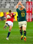 24 July 2021; Dan Biggar of British and Irish Lions kicks the ball under pressure from Steven Kitshoff of South Africa during the first test of the British and Irish Lions tour match between South Africa and British and Irish Lions at Cape Town Stadium in Cape Town, South Africa. Photo by Ashley Vlotman/Sportsfile