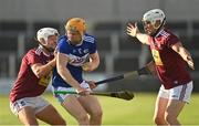 24 July 2021; Podge Delaney of Laois in action against Robbie Greville, left, and Joey Boyle of Westmeath  during the Allianz Hurling League Division 1 Relegation Play-off match between Laois and Westmeath at MW Hire O'Moore Park in Portlaoise, Co Laois. Photo by Harry Murphy/Sportsfile