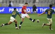 24 July 2021; Owen Farrell of the British and Irish Lions kicks a ball through while under pressure from Elton Jantjies, left, and Damian de Allende of South Africa during the first test of the British and Irish Lions tour match between South Africa and British and Irish Lions at Cape Town Stadium in Cape Town, South Africa. Photo by Ashley Vlotman/Sportsfile