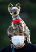 25 July 2021; A member of the public poses with his dog as he awaits to greet athletes and officials leaving Enoshima Yacht Harbour during the 2020 Tokyo Summer Olympic Games in Tokyo, Japan. Photo by Stephen McCarthy/Sportsfile