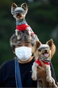 25 July 2021; A member of the public poses with his dogs as he awaits to greet athletes and officials leaving Enoshima Yacht Harbour during the 2020 Tokyo Summer Olympic Games in Tokyo, Japan. Photo by Stephen McCarthy/Sportsfile