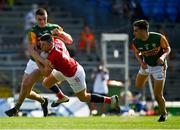 25 July 2021; Luke Connolly of Cork of Cork is tackled by Seán O’Shea of Kerry during the Munster GAA Football Senior Championship Final match between Kerry and Cork at Fitzgerald Stadium in Killarney, Kerry. Photo by Eóin Noonan/Sportsfile