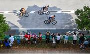 26 July 2021; Triathletes pass spectators during the cycling discipline of the men's triathlon at the Odaiba Marine Park during the 2020 Tokyo Summer Olympic Games in Tokyo, Japan. Photo by Ramsey Cardy/Sportsfile