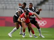 26 July 2021; Justin Douglas of Canada is tackled by Jiuta Wainiqolo, left, and Kalione Nasoko of Fiji during the rugby sevens men's pool B match between Fiji and Canada at the Tokyo Stadium during the 2020 Tokyo Summer Olympic Games in Tokyo, Japan. Photo by Stephen McCarthy/Sportsfile