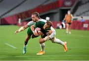 26 July 2021; Hugo Lennox of Ireland scores a try despite the tackle of Steve Tomasin of USA during the rugby sevens men's pool C match between Ireland and USA at the Tokyo Stadium during the 2020 Tokyo Summer Olympic Games in Tokyo, Japan. Photo by Stephen McCarthy/Sportsfile