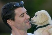 19 February 2004; Manchester United captain Roy Keane pictured with 8 week old Jessie at the launch of The Irish Guide Dogs For The Blind / Specsavers 'Shades for a Day Campaign'. The Radisson SAS St. Helen's Hotel, Stillorgan Road, Dublin. Picture credit; Matt Browne / SPORTSFILE *EDI*