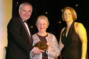 28 February 2004; Nancy McCarthy, on behalf of the late Sophie Brack, her sister, who was named on the Camogie team of the Century, with An Taoiseach, Bertie Ahern, TD, and Miriam O'Callaghan, Uachtaran, Cumann Camogaiochta na nGael, at the Cumann Camogaiochta na nGael centenary celebrations at the Citywest Hotel, Dublin. Picture credit; Ray McManus / SPORTSFILE *EDI*