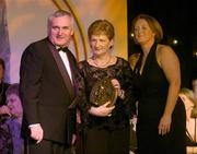 28 February 2004; Mary Fennelly, on behalf of Angela Downey Browne, Kilkenny, who was named on the Camogie team of the Century, with An Taoiseach, Bertie Ahern, T.D,  and Miriam O'Callaghan, Uachtaran, Cumann Camogaiochta na nGael, at the Cumann Camogaiocht na nGael centenary celebrations at the Citywest Hotel, Dublin. Picture credit; Brendan Moran / SPORTSFILE *EDI*