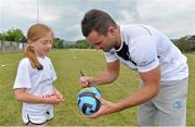 17 July 2013; Leinster's Dave Kearney signs a ball for Emma Kennedy, age 9, from Greystones, Co. Wicklow, during a Leinster Rugby summer camp. Greystones RFC Summer Camp, Greystones RFC, Co. Wicklow. Picture credit: Barry Cregg / SPORTSFILE
