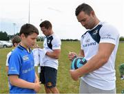 17 July 2013; Leinster's Dave Kearney signs a ball for Cameron O'Hara, age 10 from Greystones, Co. Wicklow, during a Leinster Rugby summer camp. Greystones RFC Summer Camp, Greystones RFC, Co. Wicklow. Picture credit: Barry Cregg / SPORTSFILE