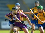 20 July 2013; Ursula Jacob, Wexford, in action against Maire McGrath and Marian O'Brien, Clare. Liberty Insurance Senior Camogie Championship Group 1, Wexford v Clare, Wexford Park, Wexford. Picture credit: David Maher / SPORTSFILE