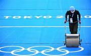 27 July 2021; A member of staff clears surface water from the track ahead of the Women's Triathlon at the Odaiba Marine Park during the 2020 Tokyo Summer Olympic Games in Tokyo, Japan. Photo by Stephen McCarthy/Sportsfile