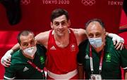 27 July 2021; Aidan Walsh of Ireland with coaches Dmitry Dmitruk, left, and Zaur Antia, right, after defeating Mengue Ayissi of Cameroon in the Men's Welterweight Round of 16 at the Kokugikan Arena during the 2020 Tokyo Summer Olympic Games in Tokyo, Japan. Photo by Ramsey Cardy/Sportsfile