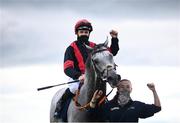 27 July 2021; Jockey Mikey Sheehy celebrates on Sirjack Thomas alongside groom Zoe Boardman after winning the Colm Quinn BMW Mile Handicap during day two of the Galway Races Summer Festival at Ballybrit Racecourse in Galway. Photo by David Fitzgerald/Sportsfile