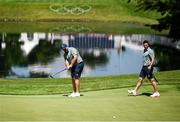 28 July 2021; Shane Lowry of Ireland, watched by Rory McIlroy, putts on the 10th green during a practice round at the Kasumigaseki Country Club during the 2020 Tokyo Summer Olympic Games in Kawagoe, Saitama, Japan. Photo by Ramsey Cardy/Sportsfile