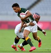 28 July 2021; Ronald Brown of South Africa is tackled by Folau Niua of United States during the Men's Rugby Sevens 5th placed play-off match between USA and South Africa at the Tokyo Stadium during the 2020 Tokyo Summer Olympic Games in Tokyo, Japan. Photo by Ramsey Cardy/Sportsfile