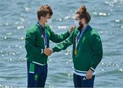 29 July 2021; Fintan McCarthy, left, and Paul O'Donovan of Ireland celebrate after with their gold medals after winning the Men's Lightweight Double Sculls final at the Sea Forest Waterway during the 2020 Tokyo Summer Olympic Games in Tokyo, Japan. Photo by Brendan Moran/Sportsfile