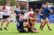 28 July 2021; Patrick Dooley of Midlands is tackled by Sean Lavin, left, and Max Gaynor of North Midlands during the Shane Horgan Cup Round 1 match between Midlands and North Midlands at Energia Park in Dublin. Photo by Sam Barnes/Sportsfile