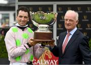 29 July 2021; Jockey Patrick Mullins celebrates with his father and trainer Willie Mullins after winning the Guinness Galway Hurdle on Saldier during day four of the Galway Races Summer Festival at Ballybrit Racecourse in Galway. Photo by David Fitzgerald/Sportsfile
