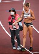30 July 2021; Kate van Buskirk of Canada is assisted off the track by a volunteer after round 1 of the women's 5000 metres at the Olympic Stadium during the 2020 Tokyo Summer Olympic Games in Tokyo, Japan. Photo by Stephen McCarthy/Sportsfile