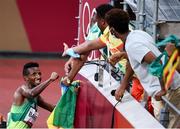 30 July 2021; Selemon Barega of Ethiopia celebrates with members of the Ethiopia delegation after winning the men's 10000 metres final at the Olympic Stadium during the 2020 Tokyo Summer Olympic Games in Tokyo, Japan. Photo by Stephen McCarthy/Sportsfile