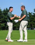 31 July 2021; Rory McIlroy, left, and Shane Lowry of Ireland exchange a handshake on the 18th green after completing round 3 of the men's individual stroke play at the Kasumigaseki Country Club during the 2020 Tokyo Summer Olympic Games in Kawagoe, Saitama, Japan. Photo by Ramsey Cardy/Sportsfile