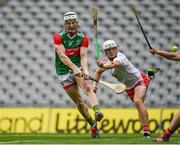 31 July 2021; Sean Regan of Mayo shoots to score his side's first goal despite the attention of Lorcan Devlin of Tyrone during the Nicky Rackard Cup Final match between Tyrone and Mayo at Croke Park in Dublin.  Photo by Harry Murphy/Sportsfile