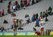 31 July 2021; Spectators seek shelter from the rain in the back of the stand during the Nicky Rackard Cup Final match between Tyrone and Mayo at Croke Park in Dublin.  Photo by Harry Murphy/Sportsfile
