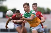 31 July 2021; Rory Egan of Offaly in action against Colm Walsh and Michael O'Neill of Cork during the 2021 EirGrid GAA All-Ireland Football U20 Championship Semi-Final match between Cork and Offaly at MW Hire O'Moore Park in Portlaoise, Laois. Photo by Matt Browne/Sportsfile