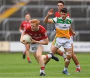 31 July 2021; Jack Cahalane of Cork in action against Cathal Flynn of Offaly during the 2021 EirGrid GAA All-Ireland Football U20 Championship Semi-Final match between Cork and Offaly at MW Hire O'Moore Park in Portlaoise, Laois. Photo by Matt Browne/Sportsfile