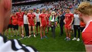 31 July 2021; Croke Park Deputy Chief Steward Mairead O’Carroll brings the Anglo Celt Cup in the middle of the Tyrone players after the Ulster GAA Football Senior Championship Final match between Monaghan and Tyrone at Croke Park in Dublin. Photo by Ray McManus/Sportsfile